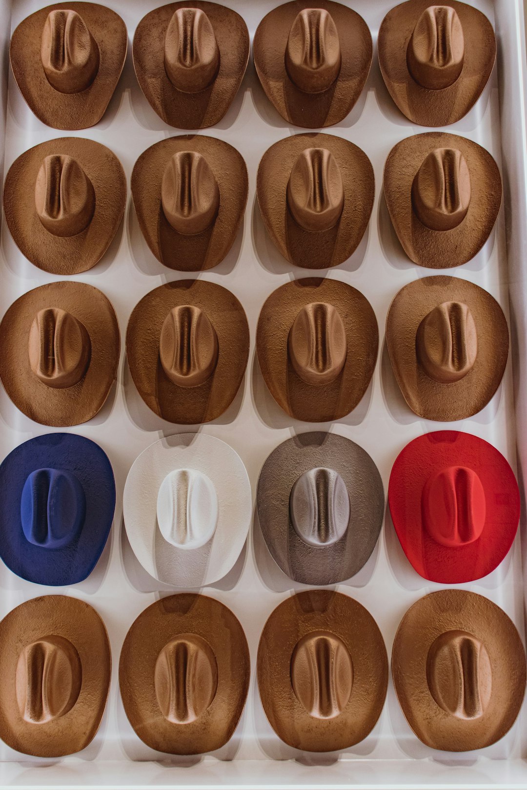 a-box-filled-with-lots-of-different-colored-cupcakes-mzvgclgbk2w