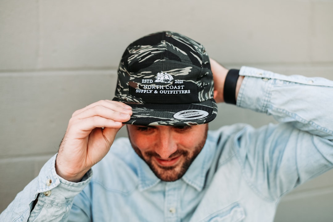 a-man-is-holding-his-hat-over-his-head-izlj-pd1vqq