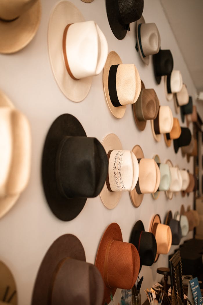 quality-assurance-01 A vibrant collection of various fedora hats hung in a store, showcasing diverse styles and colors.